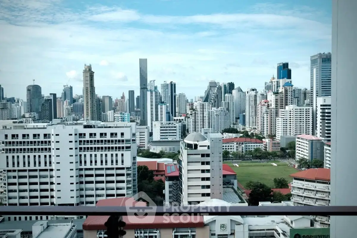Stunning city skyline view from a high-rise balcony, showcasing modern urban architecture.