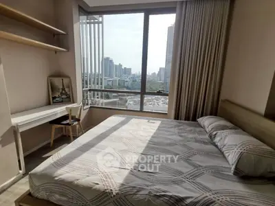 Modern bedroom with large window offering stunning city view, featuring a cozy bed and a stylish study area.