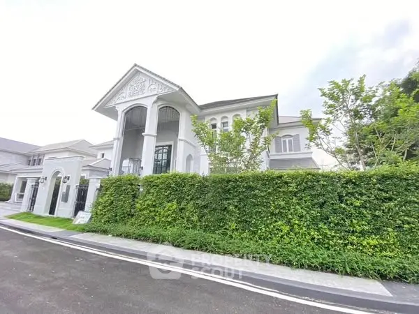 Luxurious modern mansion with elegant architectural design and lush greenery