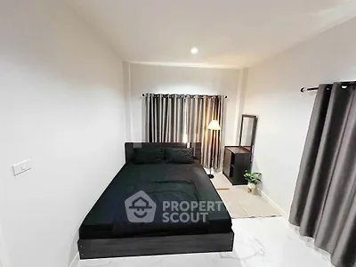 Modern minimalist bedroom with black bed and stylish decor