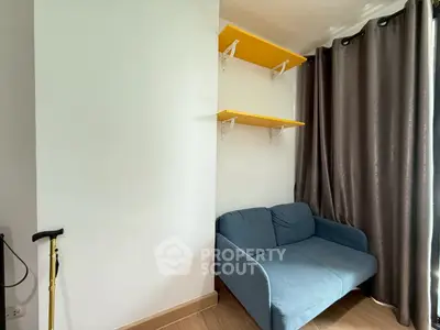 Cozy corner with blue sofa and yellow shelves in modern apartment