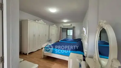 Elegant bedroom with classic white furniture and blue bedding