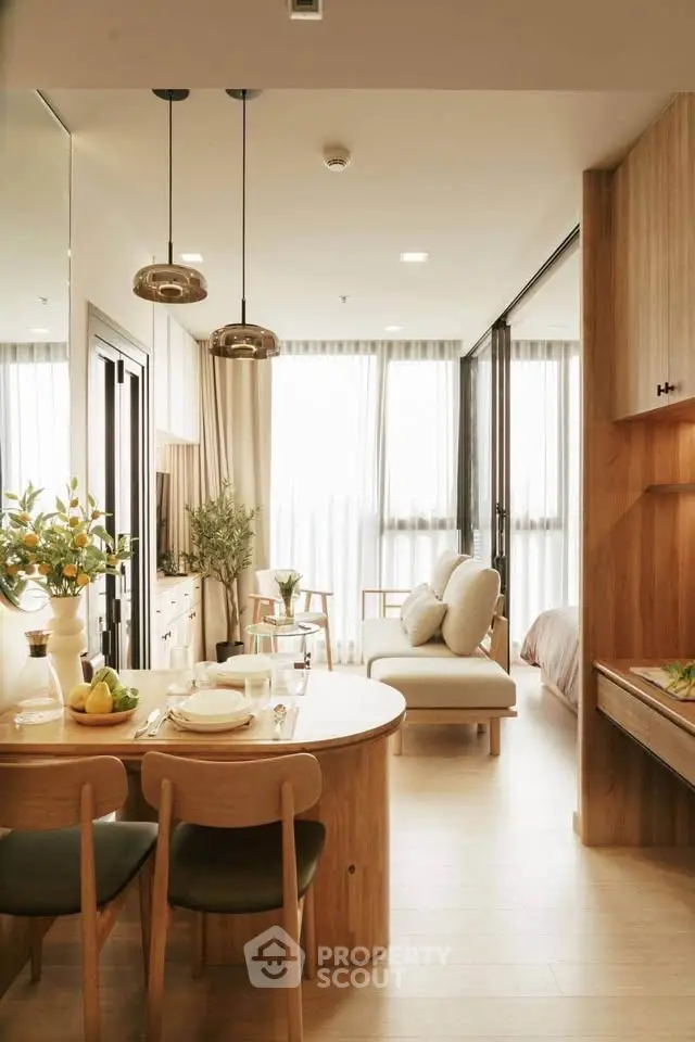 Modern open-plan living and dining area with natural light and stylish decor