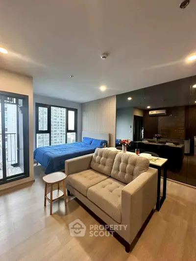 Modern studio apartment with open layout and city view balcony.