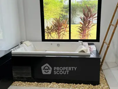Luxurious bathroom with modern bathtub and garden view
