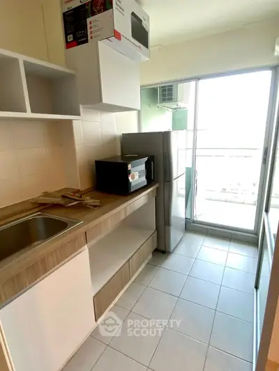 Modern kitchen with sleek appliances and balcony view