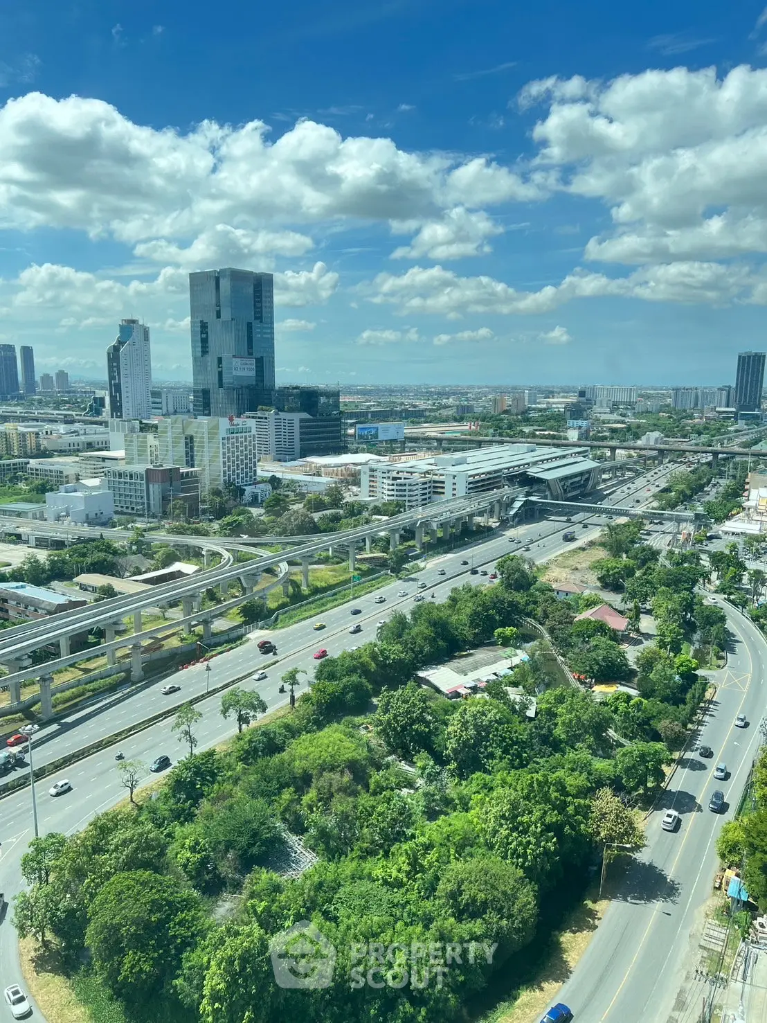 Stunning cityscape view showcasing modern skyscrapers and lush greenery, perfect for urban living enthusiasts.