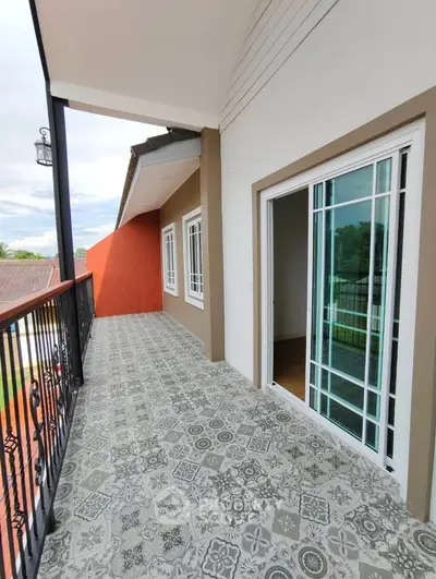 Spacious balcony with patterned tiles and sliding glass doors in modern home