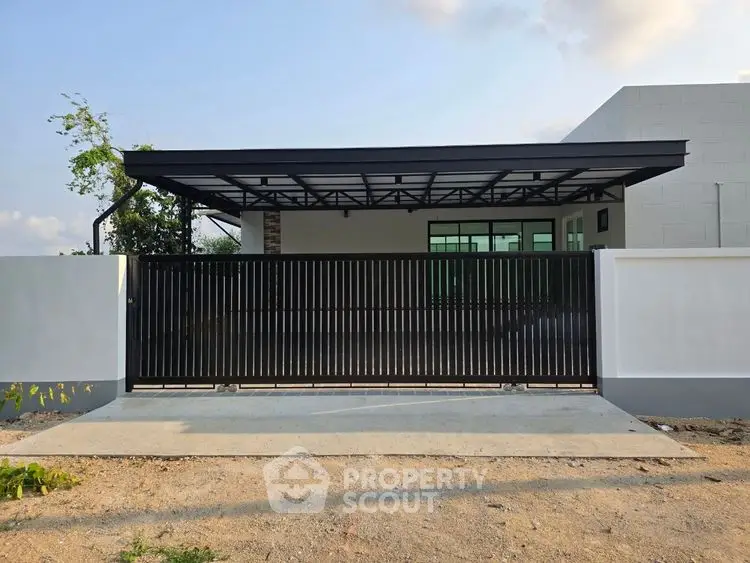 Modern house exterior with sleek black gate and spacious driveway