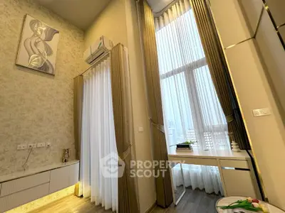 Modern high-ceiling living room with elegant decor and large windows