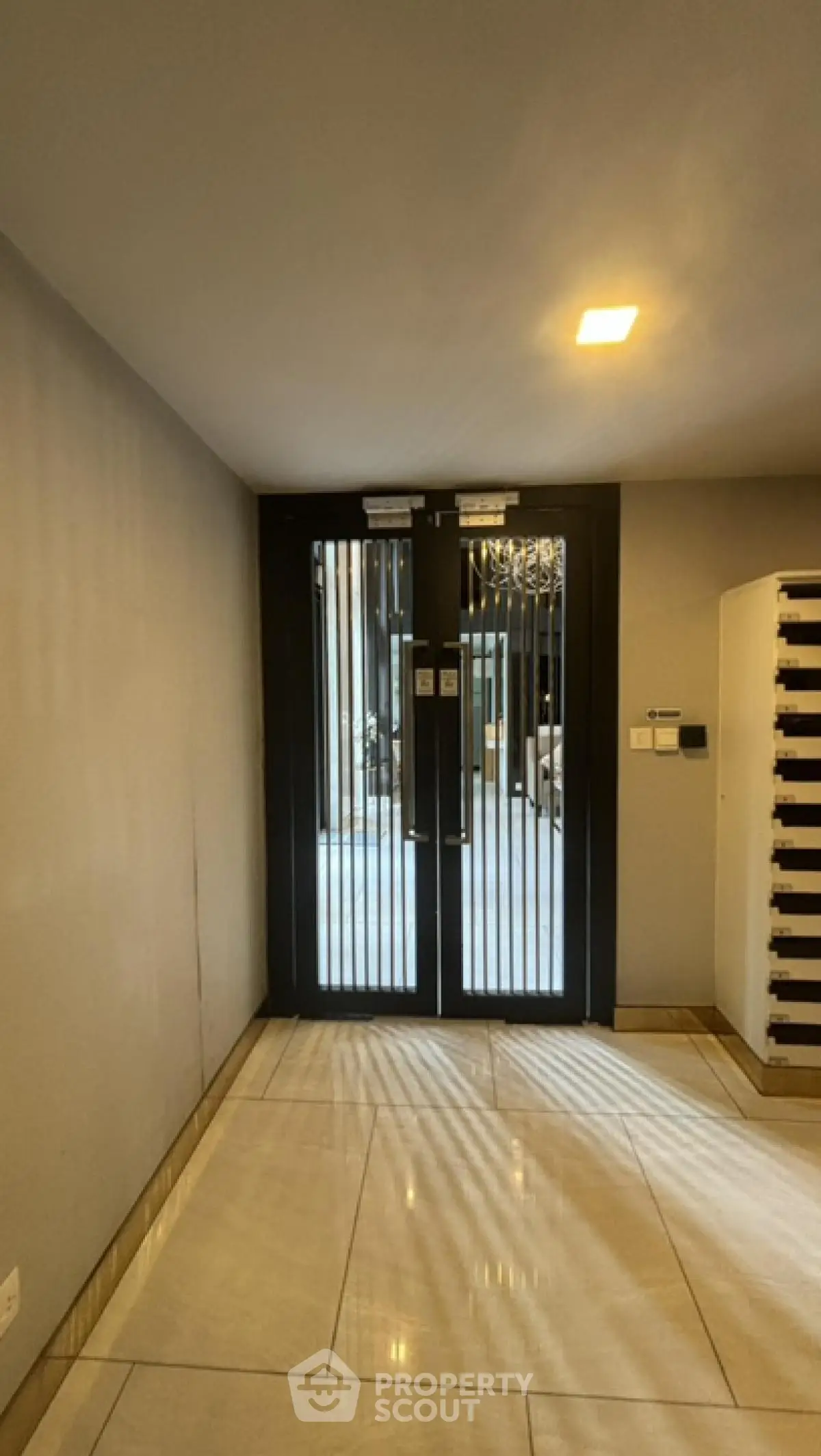 Modern building entrance with sleek design and secure double doors