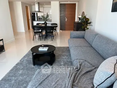 Spacious modern living room with open kitchen and stylish furnishings in a contemporary apartment.