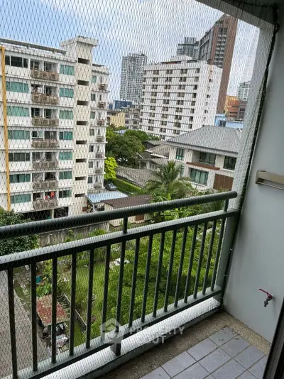 Urban balcony with safety netting and cityscape view