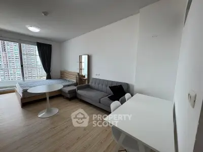 Modern studio apartment with stylish furniture and large window view