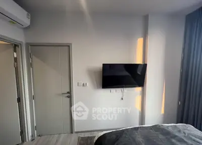 Modern bedroom with wall-mounted TV and sleek design