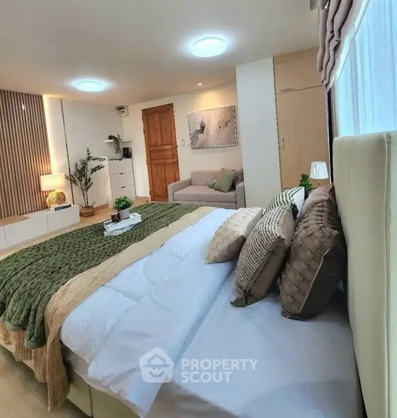 Luxurious bedroom with elegant decor and cozy ambiance, featuring plush bedding and stylish furnishings.