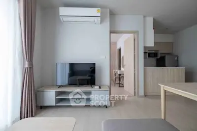 Modern living room with air conditioning and open kitchen layout in a stylish apartment.