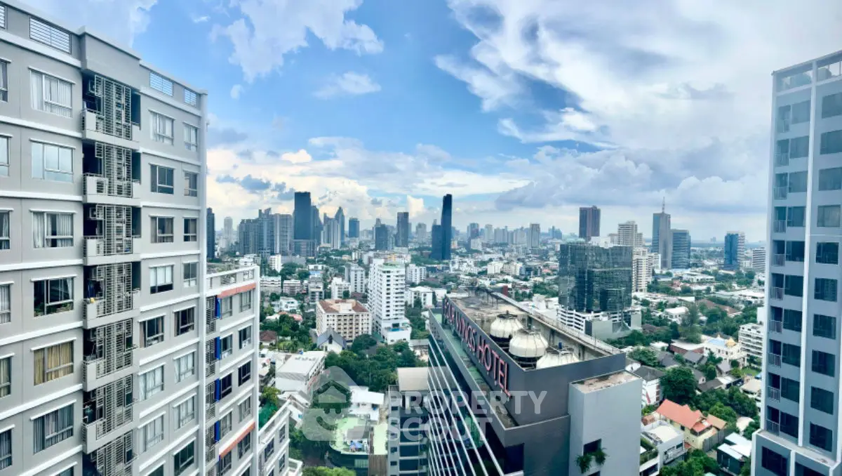 Stunning panoramic cityscape view from high-rise building balcony in urban skyline.