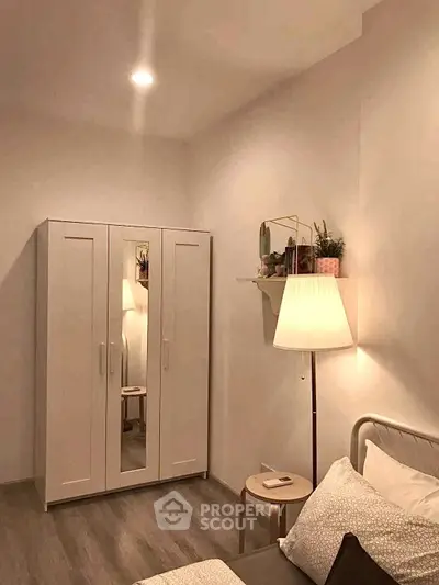 Cozy bedroom with wardrobe and soft lighting, perfect for relaxation.