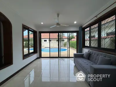 Spacious living room with pool view and modern furnishings in luxury home