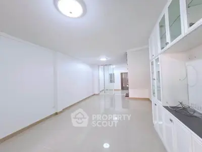 Spacious and bright living room with built-in cabinets and modern lighting