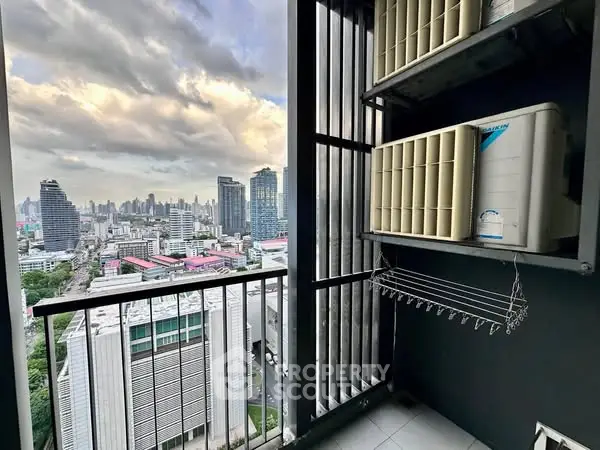 Stunning cityscape view from a high-rise balcony with modern air conditioning units.