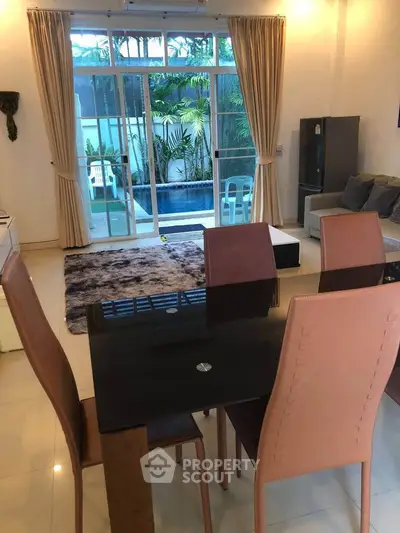 Spacious living room with modern dining set and garden view
