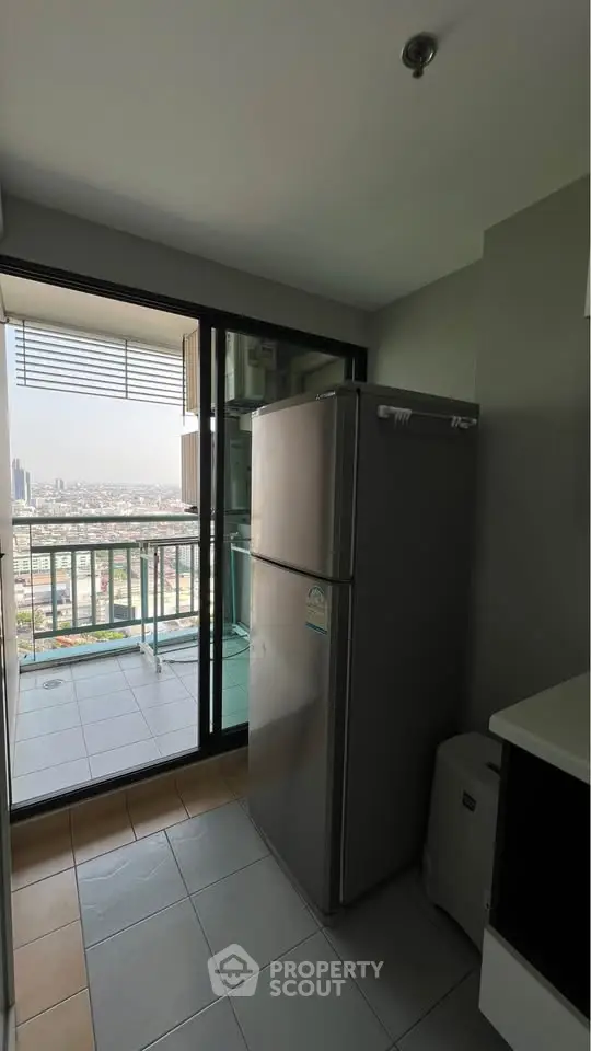 Modern kitchen with fridge and balcony offering stunning city view