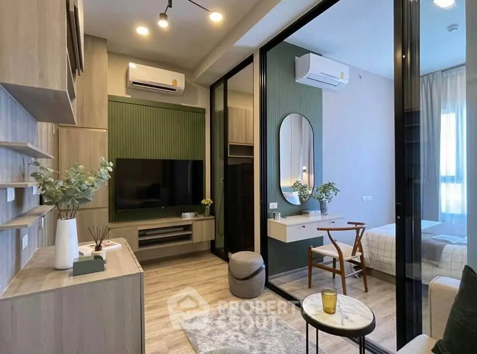 Modern living room with stylish decor and glass partition leading to cozy bedroom.