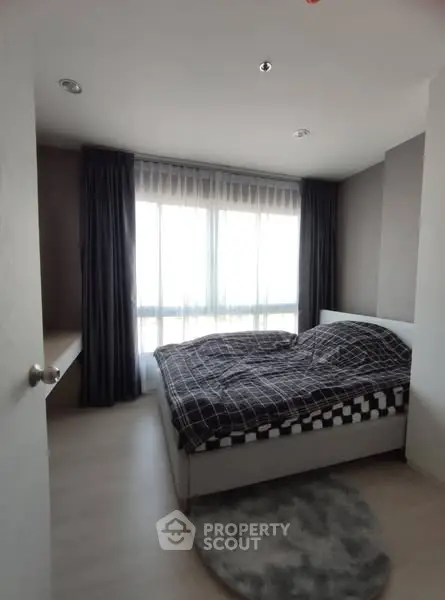 Cozy bedroom with large window and modern decor