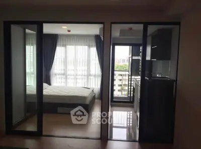 Modern apartment with glass partitions, bedroom, and balcony view