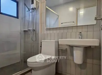 Modern bathroom with sleek fixtures and glass shower enclosure