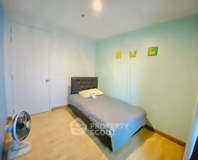 Cozy bedroom with single bed and modern decor in a bright apartment.