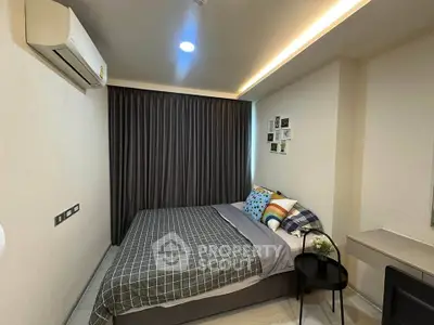 Cozy bedroom with modern decor and air conditioning in a stylish apartment.