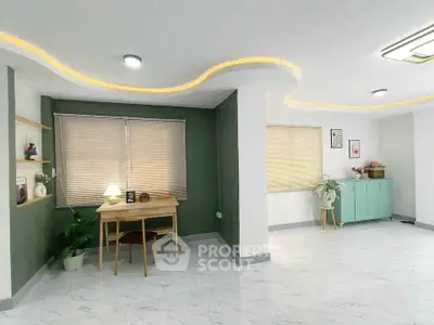 Spacious modern living room with stylish decor and ample natural light.
