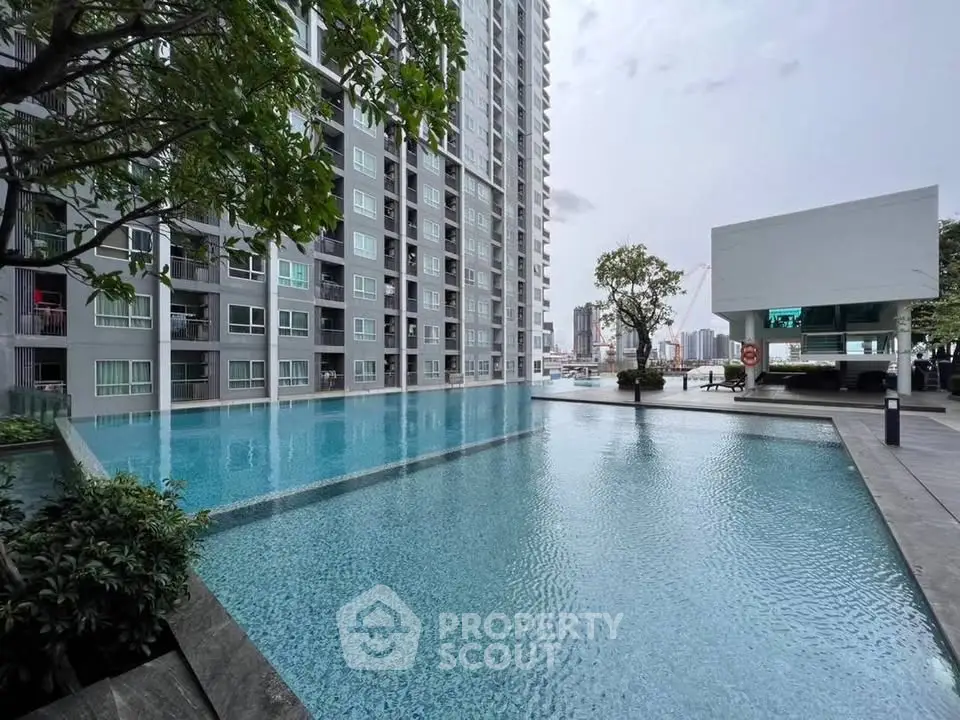 Luxurious high-rise apartment with stunning pool and cityscape view, perfect for urban living.