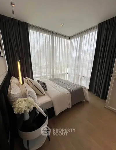 Luxurious corner bedroom with floor-to-ceiling windows and elegant decor