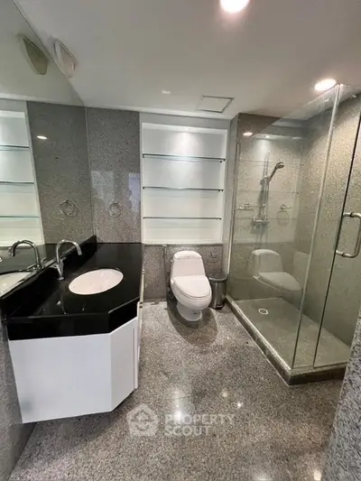 Modern bathroom with glass shower and sleek fixtures