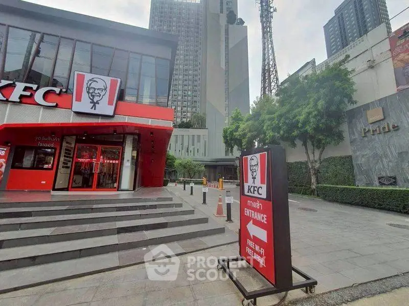 Modern commercial building exterior with KFC signage and urban surroundings.