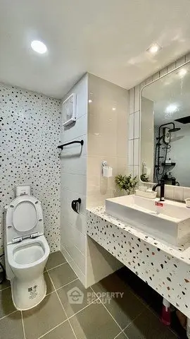 Modern bathroom with terrazzo tiles and sleek fixtures