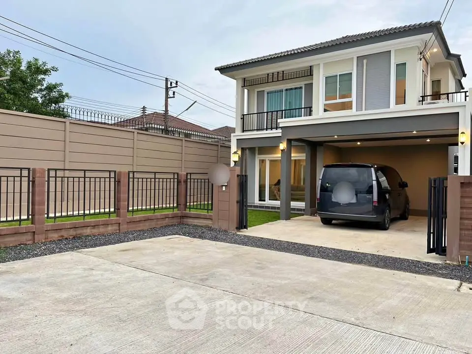 Modern two-story house with driveway and carport in a suburban setting.