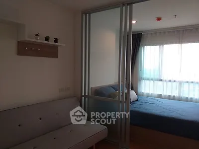 Modern apartment with sliding glass partition and cozy bedroom