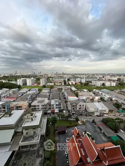 Stunning cityscape view from high-rise building with dramatic cloudy sky