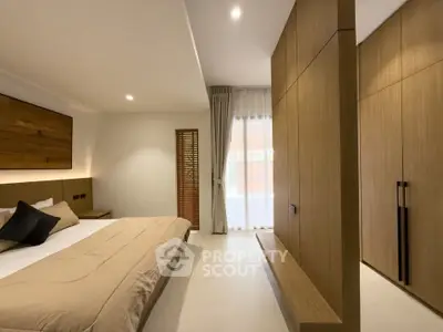 Spacious modern bedroom with elegant wooden accents and natural light