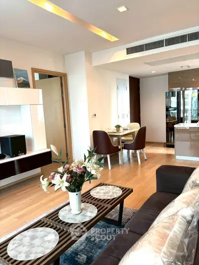 Modern living room with elegant decor and dining area in open layout apartment.