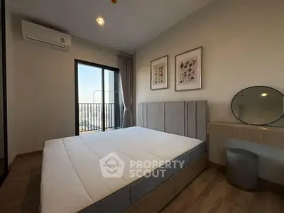 Modern bedroom with balcony view, featuring minimalist decor and natural light.