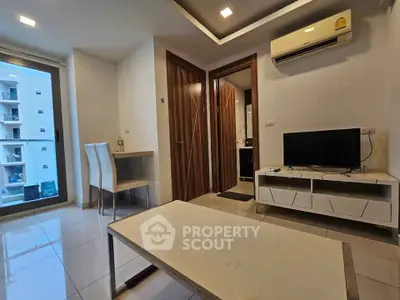 Modern living room with sleek furniture and large window offering city view.