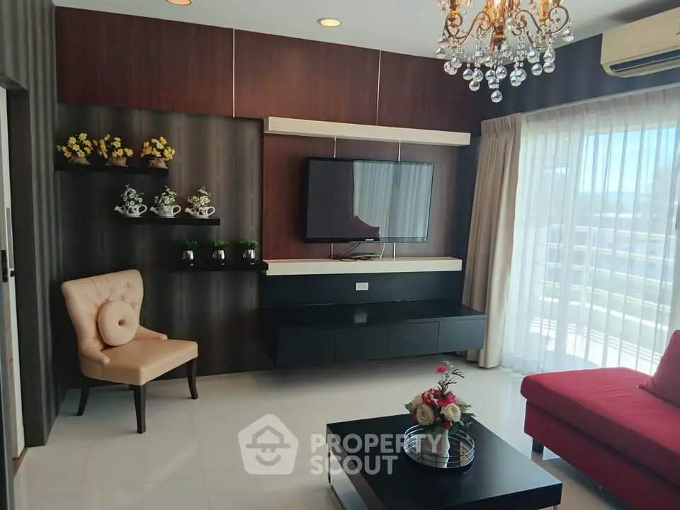 Elegant living room with modern decor, chandelier, and large window for natural light.