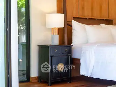 Elegant bedroom with modern nightstand and cozy bed near large window