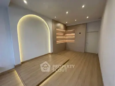 Modern minimalist room with wooden flooring and ambient lighting